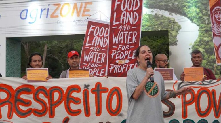 Climate activists at COP30 confront industry lobbyists at AgriZone, kicking off 1st week of negotiations